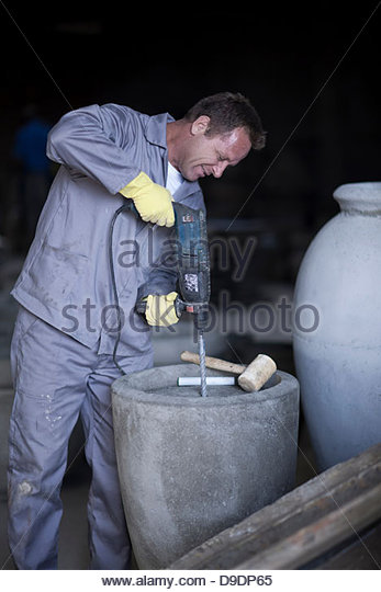 factory-worker-drilling-into-large-vase-d9dp65.jpg